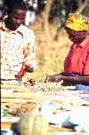 Farmer exhibiting seeds to her neighbour at the 1998 Maragwa Seed Show, Kenya